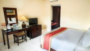 Voodi või voodid majutusasutuse The Jayakarta Yogyakarta Hotel & Spa toas