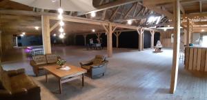 a large room with couches and a table in a building at Abrahams Camp in Flisehult