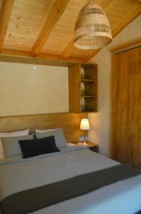 a bedroom with a large bed with a ceiling at Cozy house in beautiful valley, close to the beach in Odeceixe