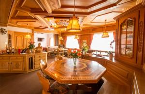 a kitchen with a wooden table and a dining room at Hotel Franz Anton in Sargans