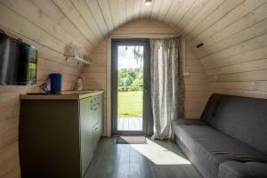 a living room with a couch and a large window at Fetingas in Šventoji