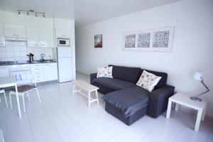a living room with a couch and a kitchen at Departamento Maria in Puerto del Carmen