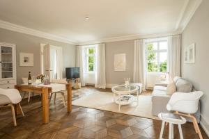 a living room with a couch and a table at Schloss Kirchberg - Rosé in Immenstaad am Bodensee