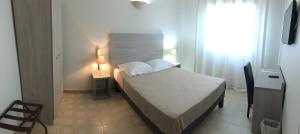 a small bedroom with a bed and a window at L'Isula Rossa in LʼÎle-Rousse +37 photos