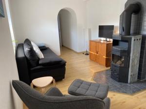 a living room with a couch and a fireplace at Apartment at Home in Rheinhausen