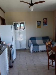 a living room with a refrigerator and a table at Vila de Sol in Bombinhas