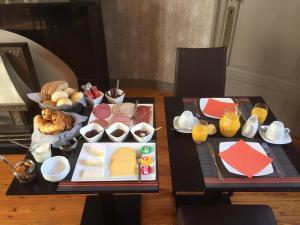 a table with cheese and other foods on it at Landhuis Vedastus in Reningelst