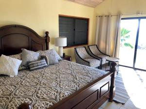 a bedroom with a large bed and a balcony at VILLA VALMARC in Virgin Gorda
