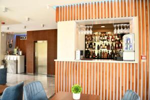 an orange and white striped bar in a restaurant at Quartz Boutique Hotel in Mamaia