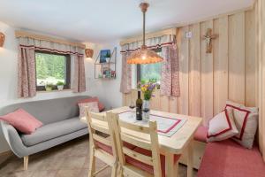 a living room with a table and a couch at Zalin planinski raj in Goreljek