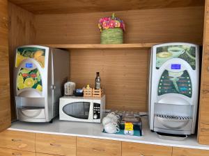 a kitchen with two microwaves and a microwave at Hotel La Perla in Marina di Massa