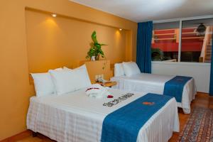 Un pat sau paturi într-o cameră la Hotel Irma