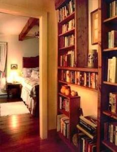 a room with book shelves filled with books at Folkestone Inn in Bryson City