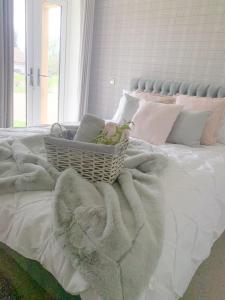 a bedroom with a bed with a basket on it at Boundary Cottage in Middleton