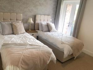 מיטה או מיטות בחדר ב-Boundary Cottage