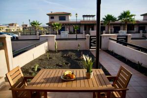 a wooden table with a bowl of fruit on a balcony at The Blue Torrent, perfect for relaxing getaway in La Oliva