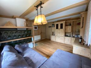 a living room with a couch and a chandelier at Ferienwohnung Dolomiten in Nußdorf +109 photos