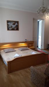 a bedroom with a large wooden bed in a room at Mero House in Kutaisi