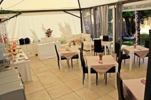 a restaurant with tables and chairs in a tent at Exclusive Passion in Rho