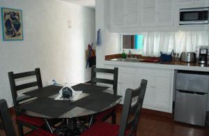 a kitchen with a table and chairs in a room at Hotel Villas Las Anclas in Cozumel