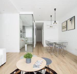 a white living room with two tables and a dining room at CARPE DIEM - Disfruta a lo grande in Pamplona