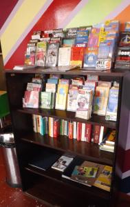 a shelf full of books in a bookstore at Le Montclair Montmartre by River in Paris