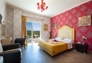a bedroom with a bed and a chair and a window at Paradice Hotel Luxury Suites-Near zorbas Beach-FREE Breakfast in Stavros