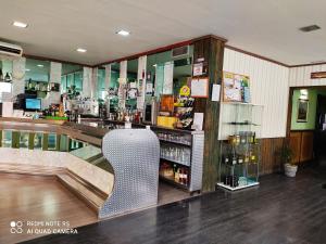 a bar with a chair in front of a counter at Hotel Querol in Valderrobres