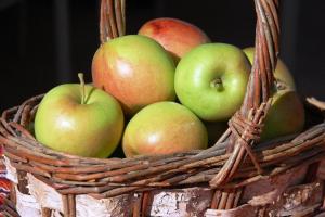 a basket filled with apples and other fruits at A Vacation Paradise at Quail Ridge B&B in Kelowna