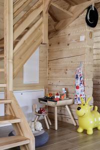 a childs play room with a wooden cabin with a table at Bukowy Raj in Wisła