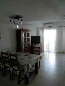 a dining room with a table and chairs and a television at Casa Montesol in Calpe