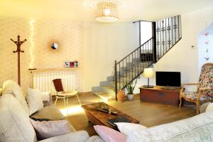 a living room with a couch and a tv at PERIQUiNA CASA RURAL CON ENCANTO in Munébrega