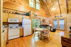 a kitchen with a white refrigerator and a table at Bear Naked in Cove Creek Cascades +7 photos