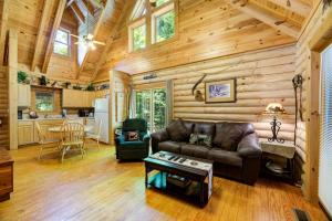 a living room with a couch and a table at Bear Naked in Cove Creek Cascades