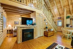 a living room with a fireplace in a log cabin at Bear Naked in Cove Creek Cascades
