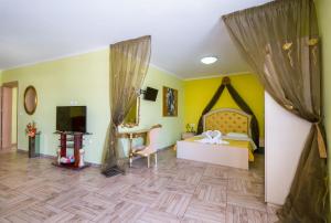 a bedroom with a bed and a desk in a room at Paradice Hotel Luxury Suites-Near zorbas Beach-FREE Breakfast in Stavros