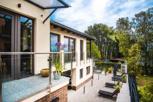 a balcony of a house with benches and windows at Kiss-Henézi Guest House in Keszthely