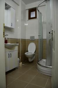 a bathroom with a toilet and a sink and a shower at Konaklar Apart Premium in Trabzon