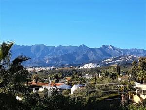 a view of a city with mountains in the background at Villa SVIM, walking distance to the beach! in Marbella