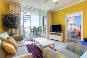 a living room with a couch and a tv at Destin West Resort in Fort Walton Beach