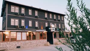 a black building with a hotel sign in front of it at Royal Park Hotel Corlu in Tekirdag