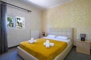 a bedroom with a large bed with two white pillows at Paradice Hotel Luxury Suites-Near zorbas Beach-FREE Breakfast in Stavros