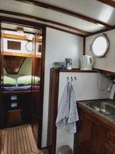 a kitchen with a sink and a counter top at Privé B&B Motorsailer Rataplan in Kamperland