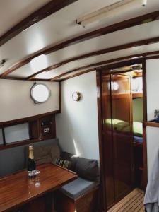 a dining room with a table in a boat at Privé B&B Motorsailer Rataplan in Kamperland