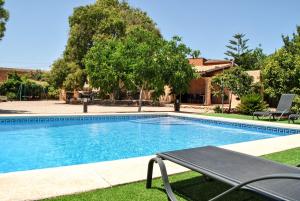 a swimming pool with a bench in a yard at 7 Xemeneies in Santa Maria del Camí