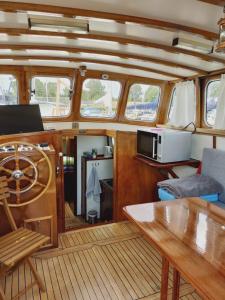a view of the inside of a boat with a table at Privé B&B Motorsailer Rataplan in Kamperland