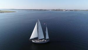an aerial view of a sail boat in the water at Privé B&B Motorsailer Rataplan in Kamperland
