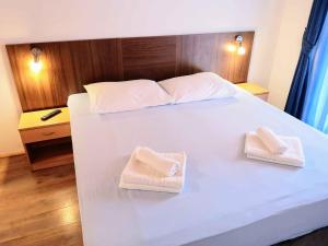 Postel nebo postele na pokoji v ubytování Guesthouse Villa Paškal