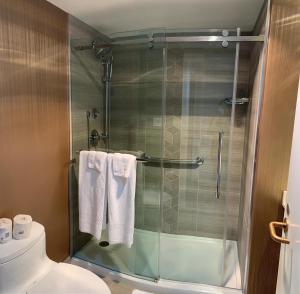 a bathroom with a shower and a toilet at Auberge Vancouver Hotel in Vancouver