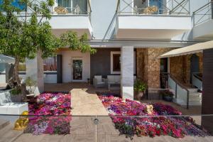 a garden in the middle of a building with flowers at Paradice Hotel Luxury Suites-Near zorbas Beach-FREE Breakfast in Stavros